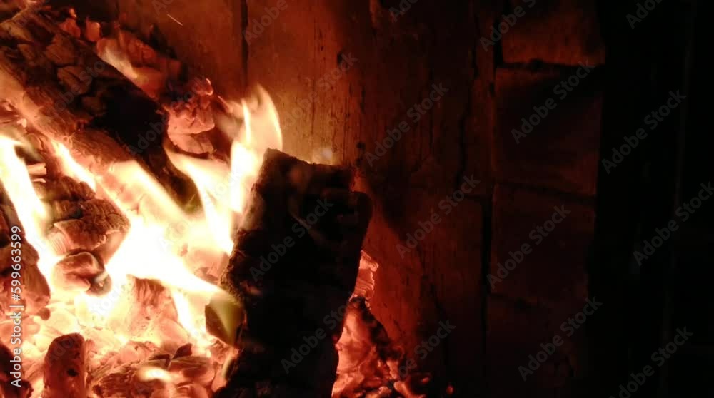 Heating by winter fireplace. Firewood is burning in the stove Heating by winter fireplace. Firewood is burning in the stove