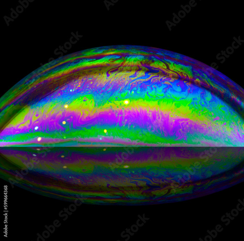 spectacular close-up of a colorful soap bubble on a black background