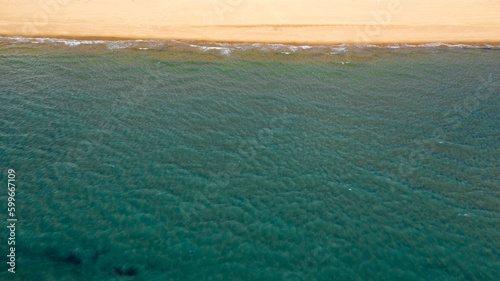 Perpendicular aerial view on a coast of the mediterranean sea near Sabaudia, in Italy. The beach is sandy.