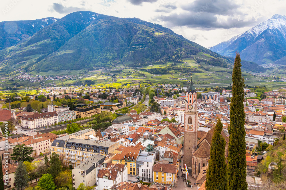 View over cityscape with Cathedral Saint Nikolaus of Merano, South tyrol, Italy seen from famous hiking trail Tappeinerweg