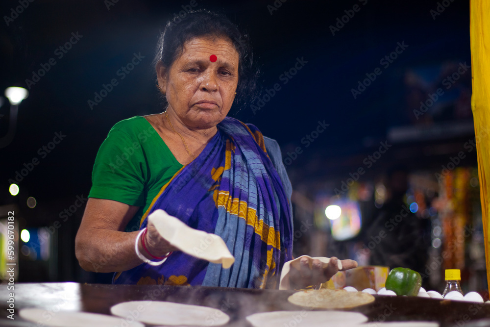 Cook of a local roadside restaurant, making bread or a roti, Local Street Food Shop Restaurant Street Vendor Cook of a local roadside restaurant, making bread or a roti, Local Street Food Shop Restaurant Street Vendor