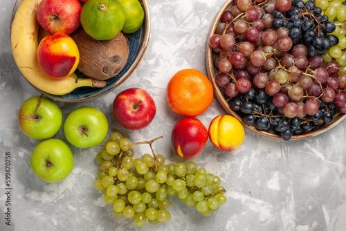 top view different grapes with other fresh fruits on light-white desk fruits fresh mellow juice summer