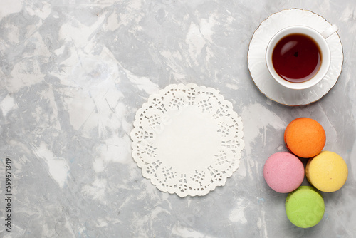 top view french macarons with cup of tea on white desk cake biscuit sweet sugar tea