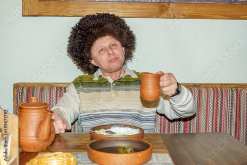 A man in a cafe eats a freshly prepared Caucasian dish. Healthy eating, balanced nutrition, the concept of food and people. photo