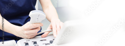 Female doctor sitting in office in a hospital doing ultrasound scanning diagnostic