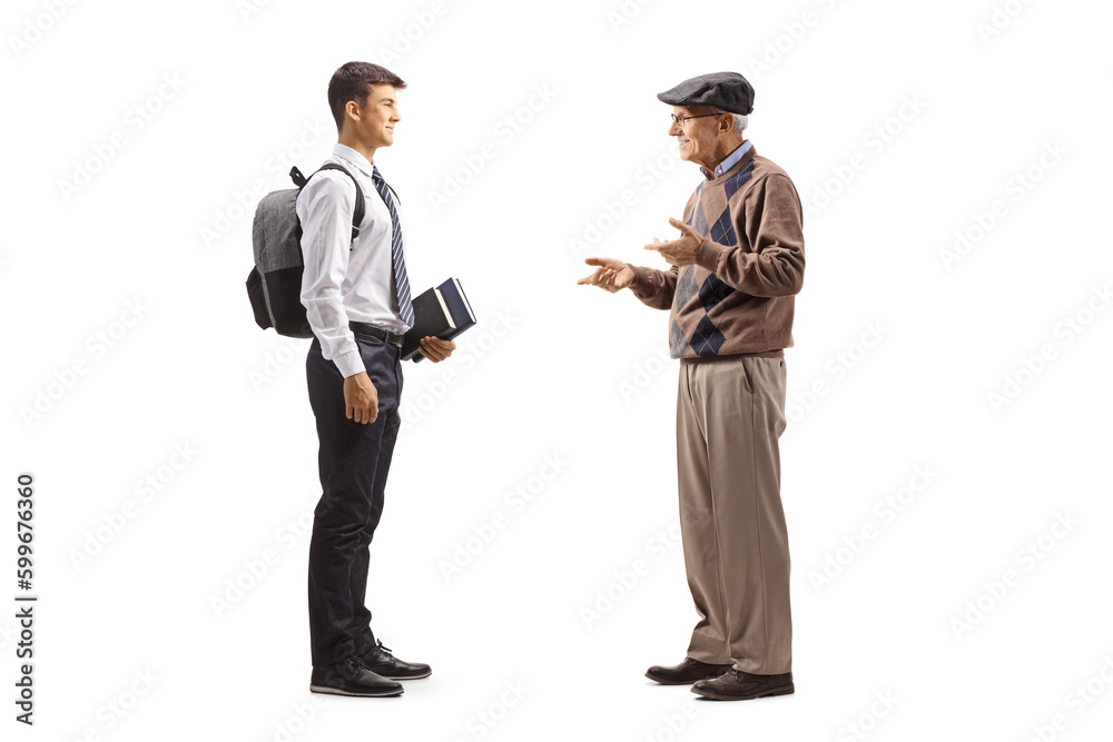 Obraz premium Full length profile shot of an elderly man talking to a male teenage student in a school uniform