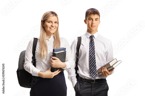 Male and female students in a uniforms holding books