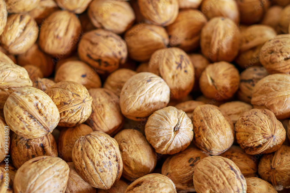 Walnuts. Lots of walnut fruits. View from above. Walnut background. Selective focus.