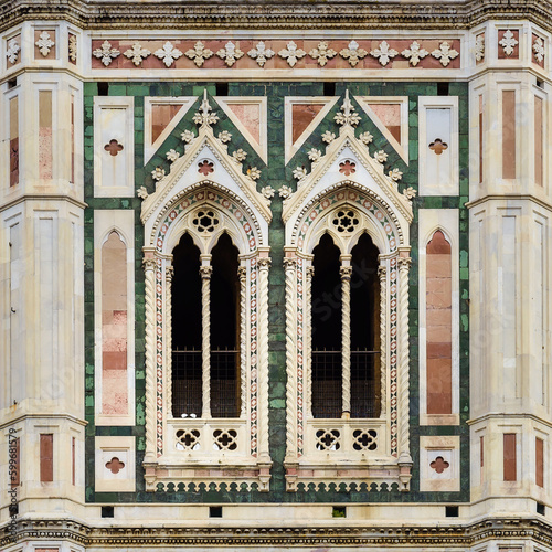 Cathedrale of Santa Maria del Fiore, Giotto Campanile with details of the exterior - is a masterpiece of Renaissance art. Close-up. Florence is a popular tourist destination of Europe.