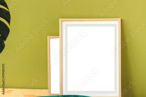 Frame on green wall in interior with place for text.