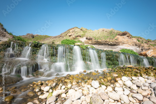 Long exposure of the waterfall flowing onto the beach at Osmington Mills in Dorset