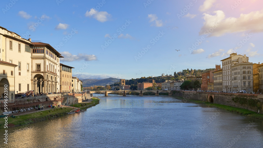 View of Arno river Florence from Ponte Vecchio with a old bridge and a flying seagull