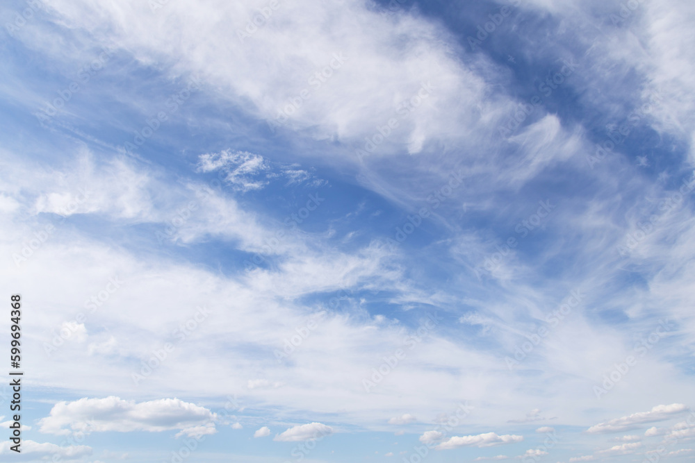 Beautiful epic soft gentle blue sky with white cirrus and fluffy cloud in sunlight background texture Beautiful epic soft gentle blue sky with white cirrus and fluffy cloud in sunlight background texture