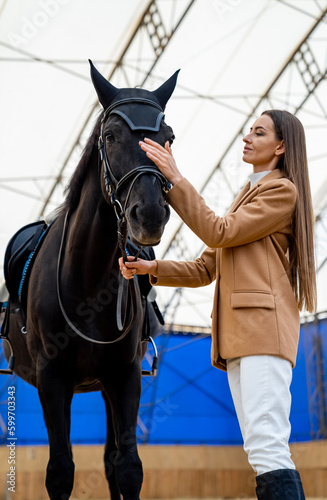 Beauty woman with elegante horse. Animal friendship wiyh young lady.