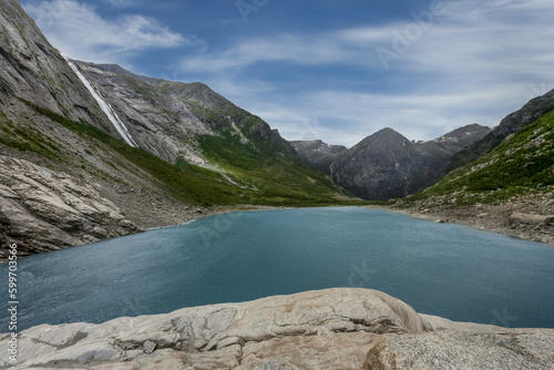 Landscape of a glacial lake with turquoise crystal clear water, Norway.