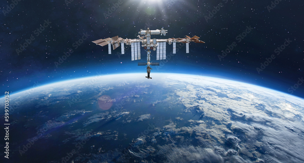 International Space station on orbit of Earth. Space wallpaper with ISS and planet surface in deep outer space. Stars in space. Astronauts in space. Elements of this image furnished by NASA - obrazy, fototapety, plakaty 