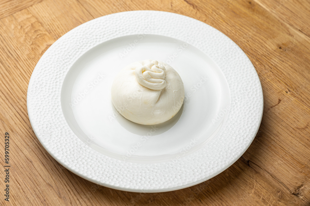 delicious buratta cheese on a white plate
delicious buratta cheese on a white plate