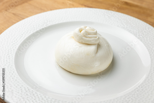 delicious buratta cheese on a white plate 