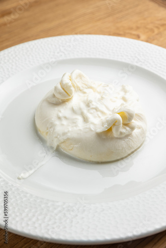 delicious buratta cheese on a white plate 