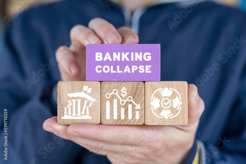 Fotografia Man holding colorful blocks with icons and inscription: BANKING COLLAPSE