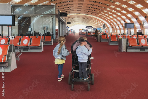 Children near the stroller in the waiting room at the airport © o1559kip
