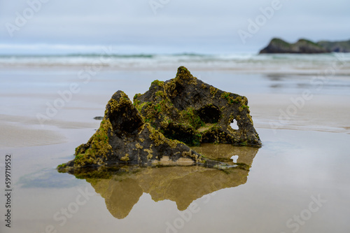 View on Playa de Borizo in Celorio, Green coast of Asturias, North Spain with sandy beaches, cliffs, hidden caves, green fields and mountains. photo