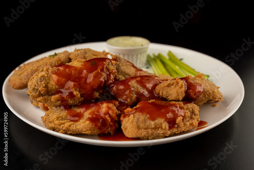 Petisco - Chicken wing seasoned and breaded with sour cream and spicy sauce