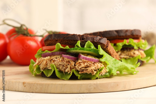 Delicious sandwiches with tuna and vegetables on white table. closeup