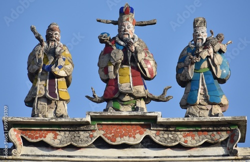 Traditional god statues on top of a Chinese temple