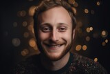 Portrait of a young man on a background of Christmas lights.