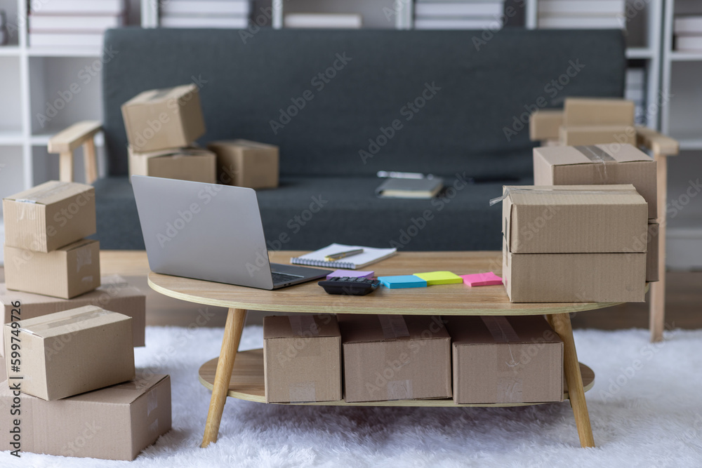 Asian business woman on sofa using a laptop computer checking customer order online shipping boxes at home. Starting SME Small business entrepreneur freelance. Online business, SME Work home concept.
Asian business woman on sofa using a laptop computer checking customer order online shipping boxes at home. Starting SME Small business entrepreneur freelance. Online business, SME Work home concept.