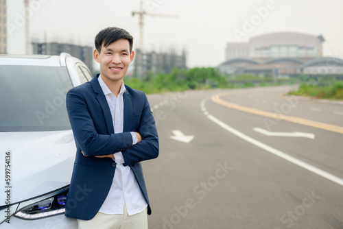 handsome young man Asian businessman in a good mood A happy smile stood near his new white car. Asian man buys a new car © เลิศลักษณ์ ทิพชัย
