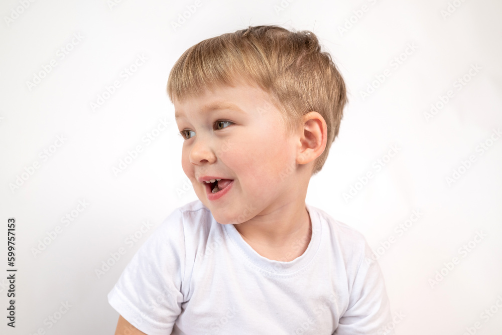Close-up portrait of a cute smiling boy in a white T-shirt on a white background. Studio snapshot Close-up portrait of a cute smiling boy in a white T-shirt on a white background. Studio snapshot