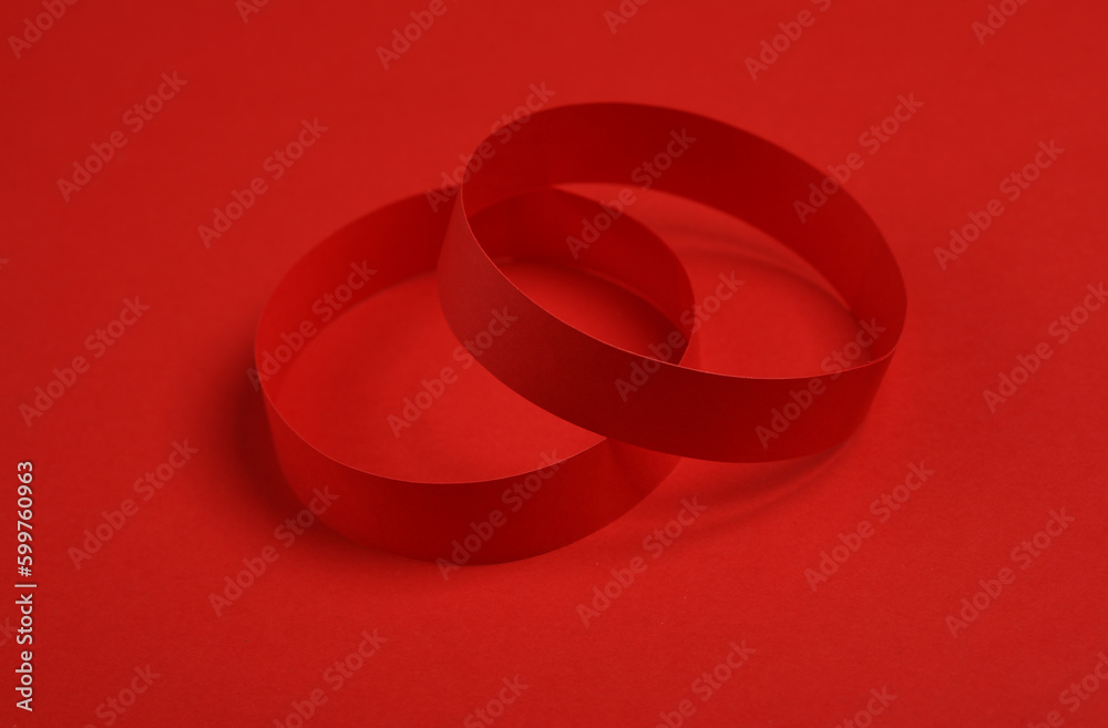 Red paper bracelets on red background Red paper bracelets on red background