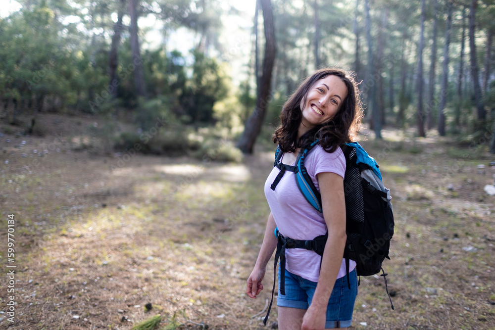 Happy smiling woman.Hiking in the mountains. Young woman tourist smiling, sports and trekking in nature. Happy smiling woman.Hiking in the mountains. Young woman tourist smiling, sports and trekking in nature.