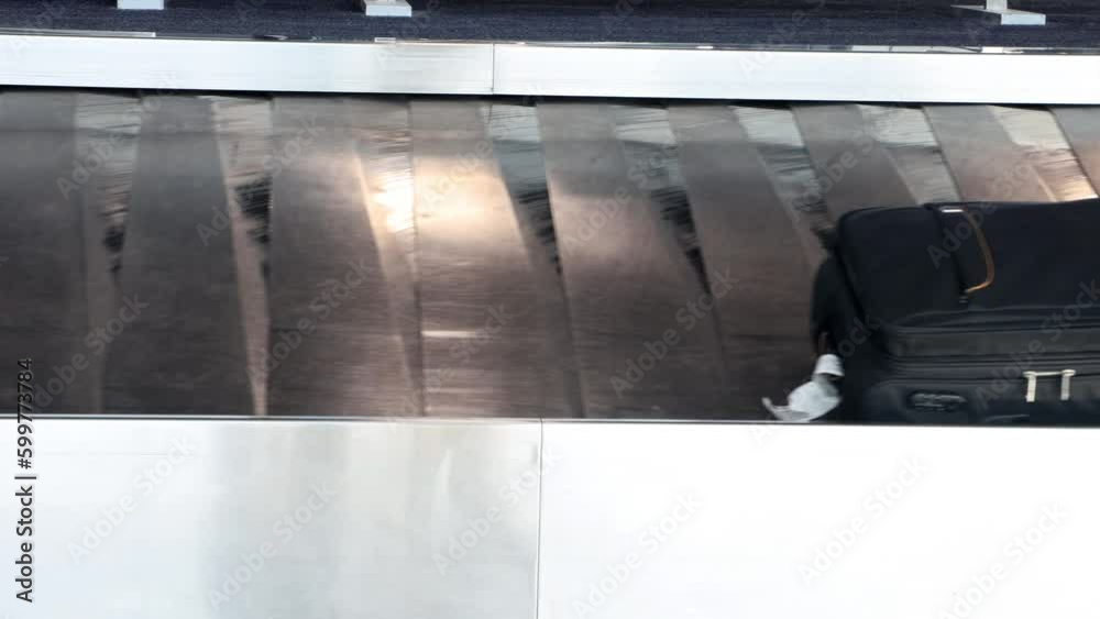The passengers' suitcases rotate on the belt at airport The passengers' suitcases rotate on the belt at airport