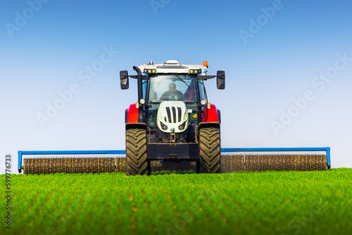 Fényképezés Tractor with a roller tillage on spring field