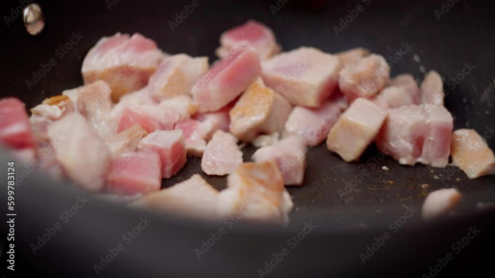 Pieces of meat with spices are fried in a pan close up. Cooking homemade food Pieces of meat with spices are fried in a pan close up. Cooking homemade food