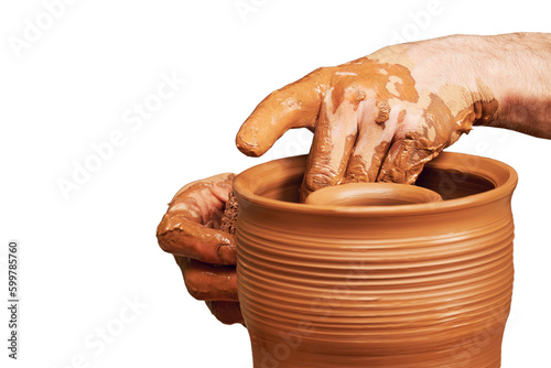 A man in old medieval Byzantine clothes sits behind a vintage potter's wheel and makes dishes out of clay, isolated on a white background. Pottery in nature in retro style.