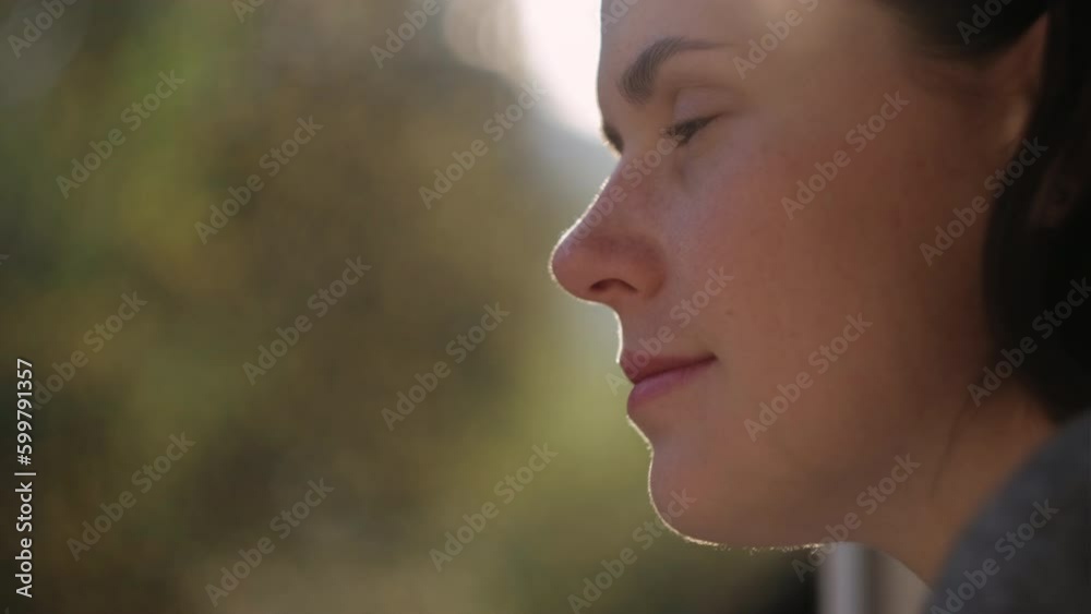 Dreamy millennial woman look in window, thinking or making plans of perspectives opportunities. Happy young female dreaming or visualizing at home during sunset on nature background. Vision concept Dreamy millennial woman look in window, thinking or making plans of perspectives opportunities. Happy young female dreaming or visualizing at home during sunset on nature background. Vision concept