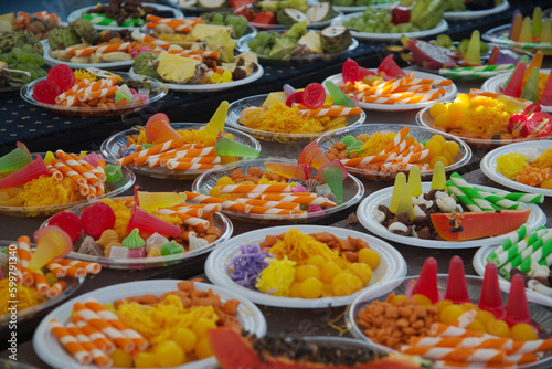 A variety of food such as local fruits, vegetables, salads, eggs, desserts are brought to the monkeys every year at Phra Prang Sam Yot Lopburi Province in Thailand.