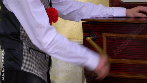 Spanish typical chulapo, street musician playing barrel organ at Madrid San Isidro traditional festival
