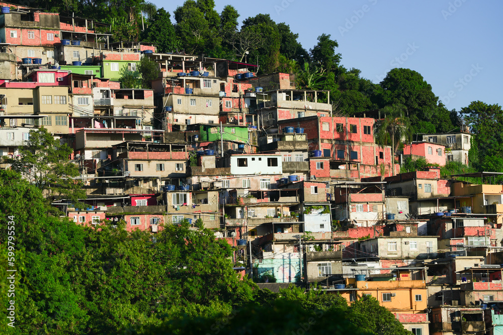 A colorful favela overlooking the Atlantic ocean in Rio de Janeiro. Beautiful sunrise view to favela on hillside in Rio de Janeiro.