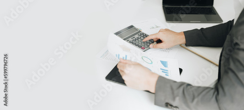 Young asian male work with financial papers at home count on calculator before paying taxes receipts online, planning budget glad to find chance for economy saving money, audit concepts.