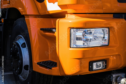 close-up part of orange truck front headlight