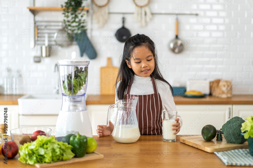 Portrait of enjoy happy little asian child girl smiling having protein breakfast drinking and hold glasses of fresh milk,healthy nutrition,calcium and vitamin,dairy product,strong and growth 