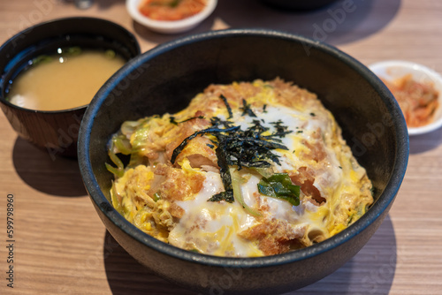 Delicious Katsudon Bowl with Soup and Gimji: A Tempting Japanese Delight in a Stylish Black Bowl