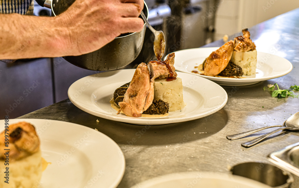 Chef working in busy kitchen preparing meals Chef working in busy kitchen preparing meals