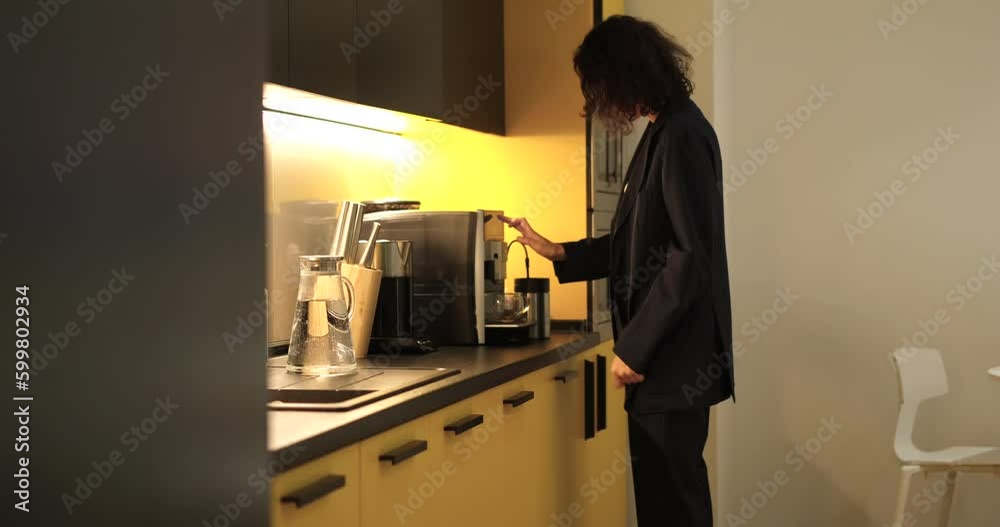 custom made wallpaper toronto digitalYoung business woman making coffee in coffee machine in the office kitchen. Woman wearing dark business suit . High quality 4k footage