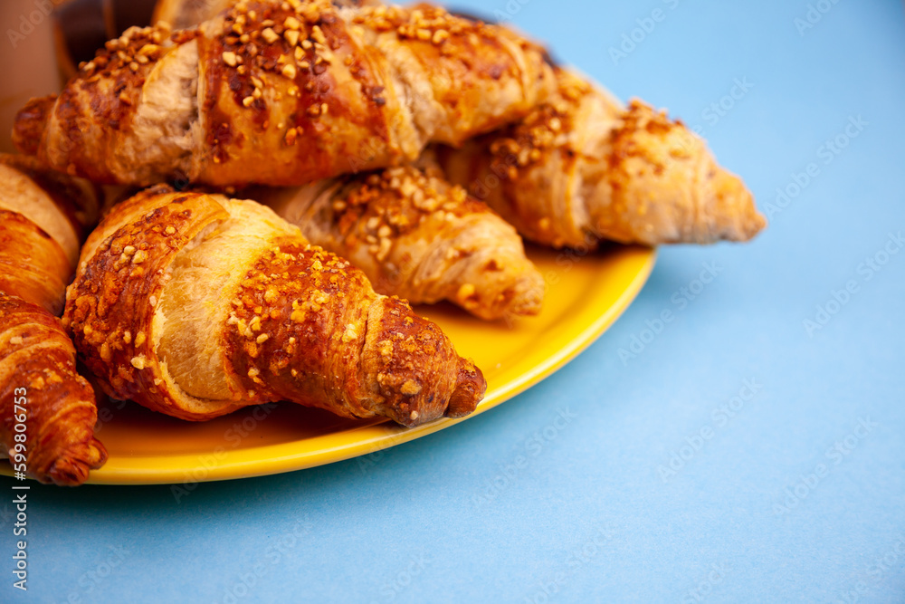 Chocolate croissants or croissant with nut crumbs on a plate. Delicious breakfast on the table. Tasty sweet baking dessert for coffee. Food background. Fresh buttery croissants rolls Chocolate croissants or croissant with nut crumbs on a plate. Delicious breakfast on the table. Tasty sweet baking dessert for coffee. Food background. Fresh buttery croissants rolls